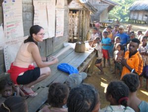 Ecologist Cullman and her research assistant, Claudin Zara (in orange), sharing preliminary research results at one of the community sites.