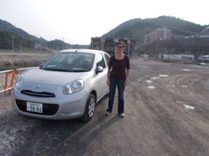 Davidson in Onagawa, Japan, to examine damage done by the tsunami that knocked the building behind her over and destroyed many others.