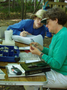 Civil Engineer-turned-Ornithologist Laura Gooch banding birds with Julie West (who's holding the bird) at Cleveland's Nature Center at Shaker Lakes.