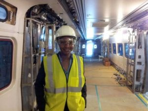 Civil Engineer Tysheina Robertson on a train, before seats have been added.