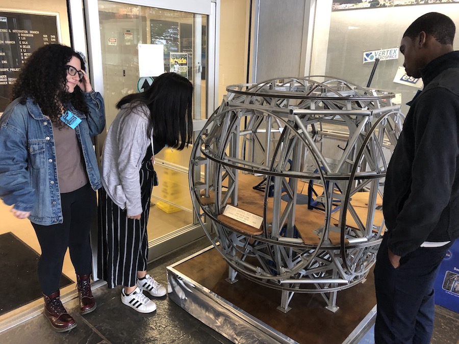 Students look at a coil system model